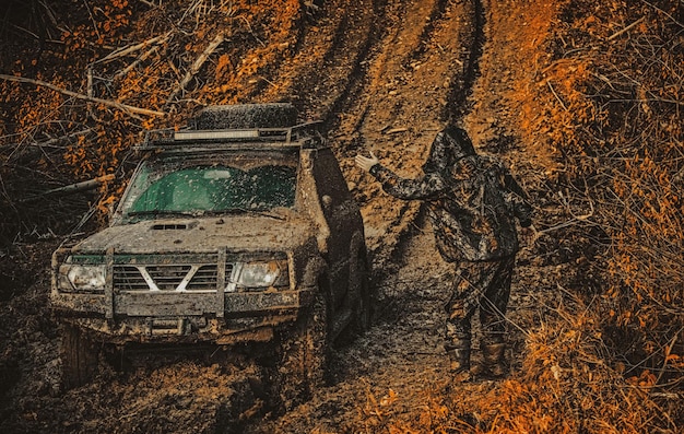 The 2025 Nissan Titan driving through a muddy off-road trail, demonstrating its 4x4 capabilities and durability.