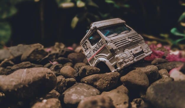 A Rivian R1T driving on a dirt road with a camping setup in the truck bed. The image captures the truck's off-road capabilities and its suitability for outdoor adventures. The background shows a scenic landscape with mountains and trees, emphasizing the R1T's rugged nature.