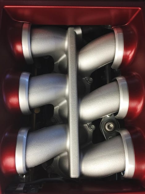 A detailed shot of the 2025 Toyota Tacoma's new turbocharged 2.4-liter engine. Highlight the turbocharger unit and the engine's overall design, emphasizing its complexity compared to the previous V6 engine.