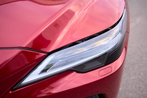 Close-up shot of the 2025 Tesla Model 3's newly designed headlights and front fascia, emphasizing the car's aggressive and aerodynamic styling. The image highlights the sleek lines and modern aesthetic.