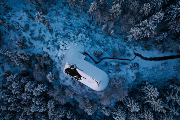 The 2025 BMW Z4 with its top down, parked against a mountain backdrop with snow-capped peaks. The car is angled to showcase its aerodynamic profile.