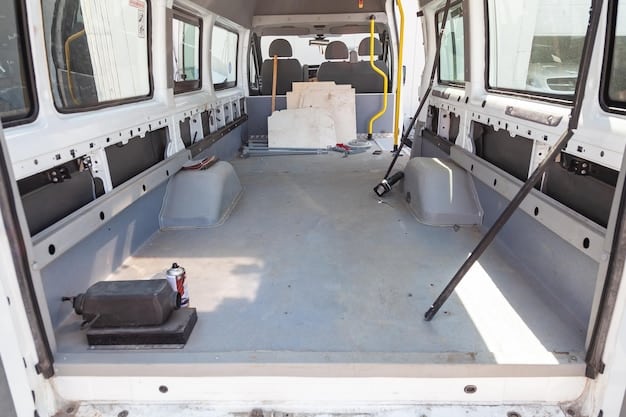 The interior of a 2025 Ford Transit, highlighting its cargo space with a focus on the tie-down points and flat floor. Various tools and equipment are neatly organized inside the van.