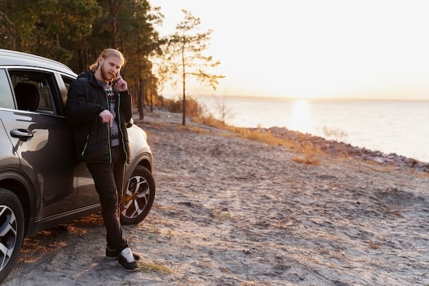 A side view of the 2025 Volvo V60 Cross Country driving on a scenic coastal highway. The car is showcasing its sleek profile, raised ride height, and all-weather capability. The image captures the beauty of the surrounding landscape and the car's ability to blend in with nature.