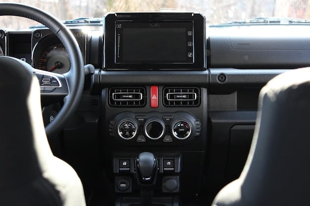 The interior of a 2025 Jeep Wrangler, highlighting the infotainment screen, dashboard layout, and comfortable seating.