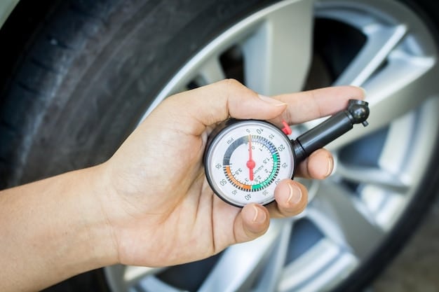 A person using a tire pressure gauge to check the pressure of a car tire. The gauge is clearly showing the pressure reading.
