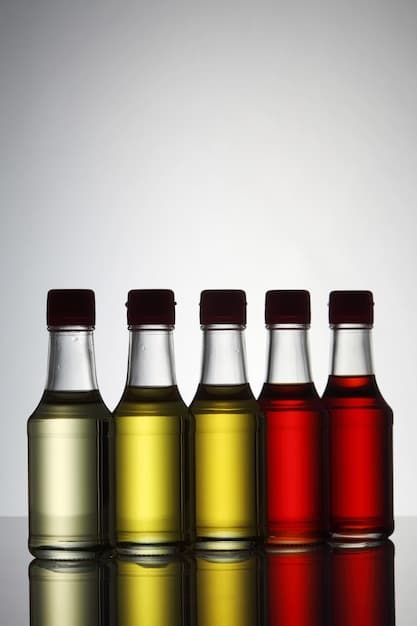 A side-by-side comparison of fresh, clean transmission fluid (bright red) and old, contaminated fluid (dark brown/black) in clear containers.