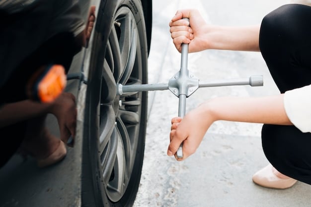 A close-up of a hand demonstrating how to check the tension of a car belt by pressing down on it between two pulleys.