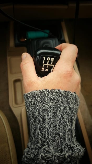A close-up shot of an OBD-II scanner displaying a diagnostic trouble code on its screen, with the car's dashboard visible in the background.