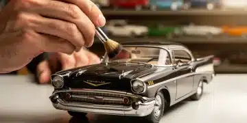 Collector carefully cleaning a vintage die-cast scale model car with a soft brush.