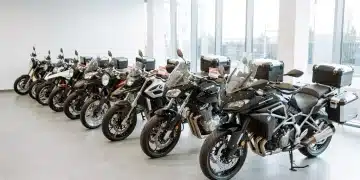 New motorcycles displayed in a bright showroom, ready for sale and indicating market growth.