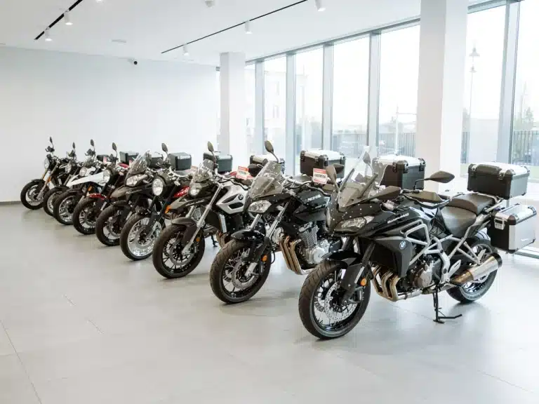 New motorcycles displayed in a bright showroom, ready for sale and indicating market growth.