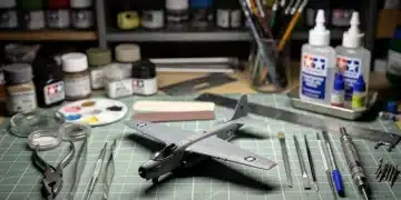 Organized workbench with essential scale model assembly tools and a partially built aircraft model