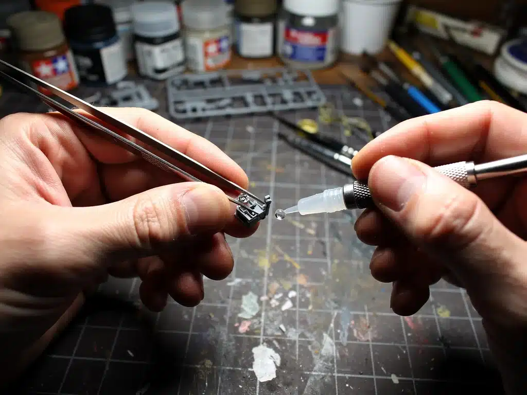 Hands using precision tweezers and glue for intricate scale model assembly detailing